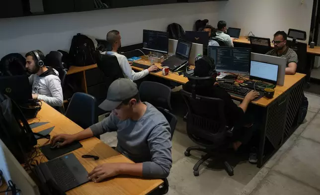 Palestinian digital freelancers work on projects for clients abroad at a coworking space in Gaza City, Tuesday, May 12, 2026. (AP Photo/Abdel Kareem Hana)