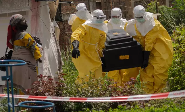A woman cries as Red Cross workers carry the coffin of a person who died of Ebola from a health center in Rwampara, Congo, Wednesday, May 20, 2026. (AP Photo/Moses Sawasawa)