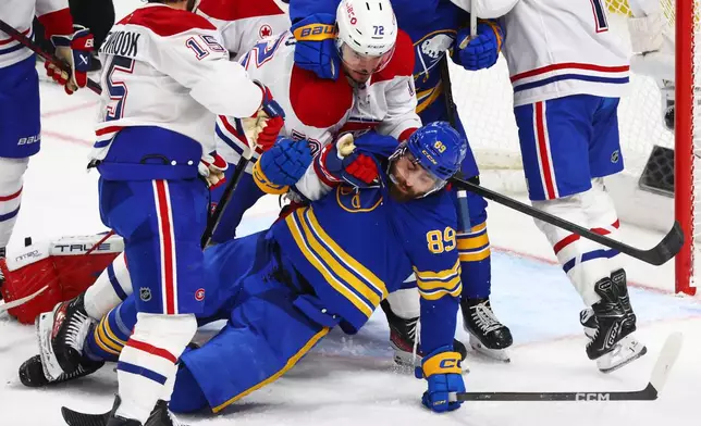Buffalo Sabres right wing Alex Tuch (89) is brought down by Montreal Canadiens defenseman Arber Xhekaj (72) during the third period in Game 5 of a second-round NHL hockey Stanley Cup playoff series, Thursday, May 14, 2026, in Buffalo, N.Y. (AP Photo/Jeffrey T. Barnes)