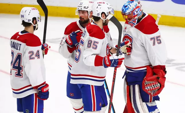 Montreal Canadiens players celebrate victory following the third period in Game 5 of a second-round NHL hockey Stanley Cup playoff series against the Buffalo Sabres, Thursday, May 14, 2026, in Buffalo, N.Y. (AP Photo/Jeffrey T. Barnes)