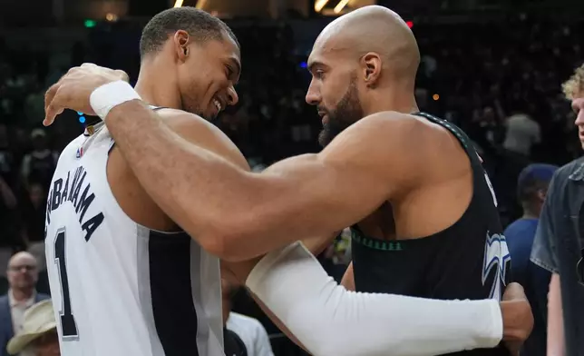 San Antonio Spurs forward Victor Wembanyama, left, and Minnesota Timberwolves center Rudy Gobert, right, greet following Game 6 of an NBA basketball second-round playoffs series in Minneapolis, Friday, May 15, 2026. (AP Photo/Abbie Parr)