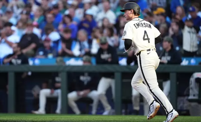 Seattle Mariners' Colt Emerson jogs to first base after drawing a walk against the San Diego Padres during the sixth inning of a baseball game, Sunday, May 17, 2026, in Seattle. (AP Photo/Lindsey Wasson)