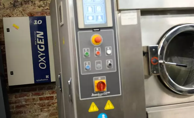 A machine that uses oxygen and ozone in place of water and chemicals to distress clothes is seen at the BPD Washhouse, a denim processing facility, in Jersey City, N.J., Tuesday, May 5, 2026. (AP Photo/Seth Wenig)