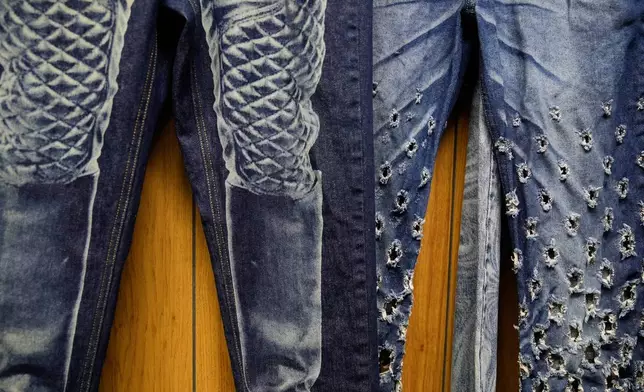 Patterns and distressing, made by a laser, are displayed at the BPD Washhouse, a denim processing facility, in Jersey City, N.J., Tuesday, May 5, 2026. (AP Photo/Seth Wenig)