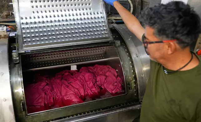 A small run of sweatshirts are dyed at the BPD Washhouse, a denim processing facility, in Jersey City, N.J., Tuesday, May 5, 2026. (AP Photo/Seth Wenig)