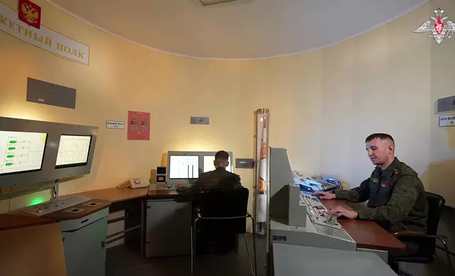 In this image made from video provided by Russian Defense Ministry Press Service on Tuesday, May 12, 2026, Russian servicemen oversee a test launch of the new Sarmat intercontinental ballistic missile at an unspecified location in Russia. (Russian Defense Ministry Press Service via AP)
