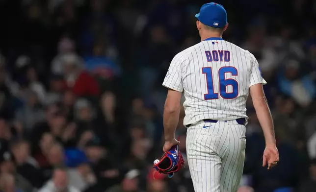 Chicago Cubs starting pitcher Michael Boyd (16) returns to the dugout after a pitching change during the fifth inning of a baseball game against the Philadelphia Phillies, Wednesday, April 22, 2026, in Chicago. (AP Photo/Erin Hooley)