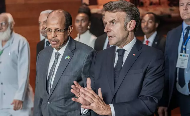 African Union Commission Chairperson Mahmoud Ali Youssouf and France's President Emmanuel Macron, right, interact at the African Union headquarters in Addis Ababa, Ethiopia, Wednesday, May 13, 2026. (AP Photo/Amanuel Sileshi)