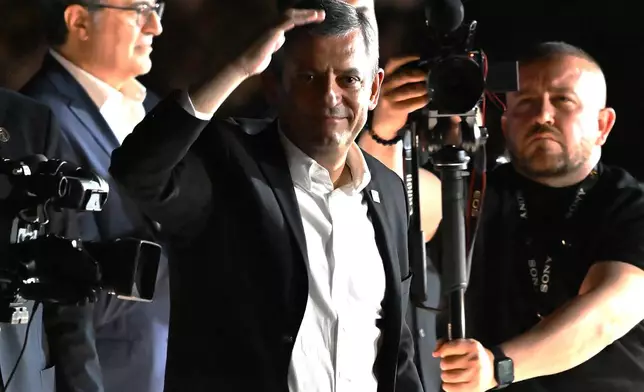 Leader of Turkey's main opposition Republican People's Party (CHP), Ozgur Ozel, addresses supporters gather outside the party's headquarters in Ankara on Friday, May 22, 2026. (AP Photo/Ali Unal)