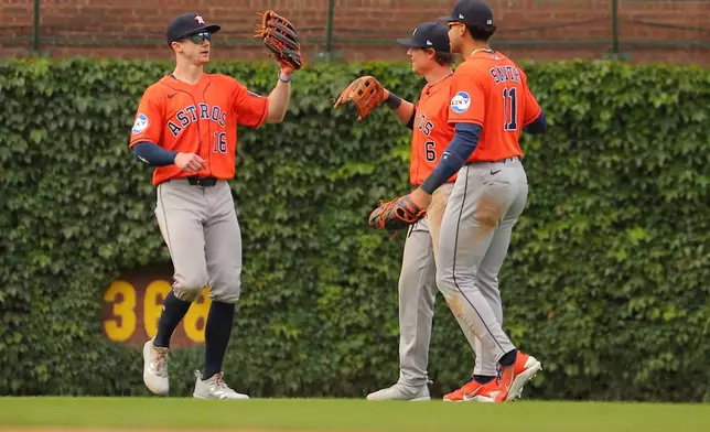Houston Astros' Zach Cole, left, Jake Meyers, middle, and Cam Smith, right, celebrate after a baseball game against the Chicago Cubs on Friday, May 22, 2026, in Chicago. (AP Photo/Melissa Tamez)