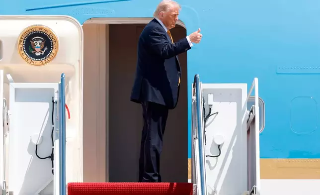 President Donald Trump gestures from the stairs of Air Force One as he boards upon his arrival at Joint Base Andrews, Md., Tuesday, May 12, 2026, for a trip to China to meet President Xi Jinping. (AP Photo/Luis M. Alvarez)