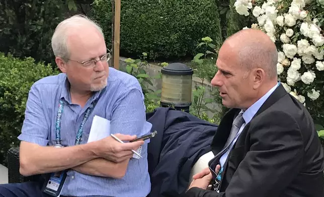 Howard Fendrich, left, Associated Press national sports writer, interviews former French tennis player Guy Forget at the 2019 French Open tennis tournament in Paris. (AP Photo/Andrew Dampf)