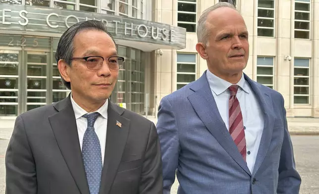 Lu Jianwang stands with his lawyer, John Carman, outside a U.S. courthouse in Brooklyn, New York, on Wednesday, May 13, 2026, following his conviction of acting as an illegal foreign agent for China. (AP Photo/Michael R. Sisak)