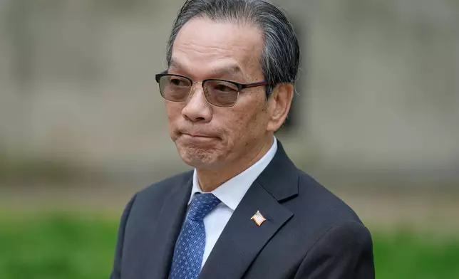 Lu Jianwang waits to enter a federal courthouse in New York, Wednesday, May 6, 2026. (AP Photo/Seth Wenig)