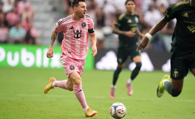 Inter Miami midfielder Leo Messi carries the ball downfield during the first half of an MLS soccer match against the Portland Timbers, Sunday, May 17, 2026, in Miami. (AP Photo/Rebecca Blackwell)