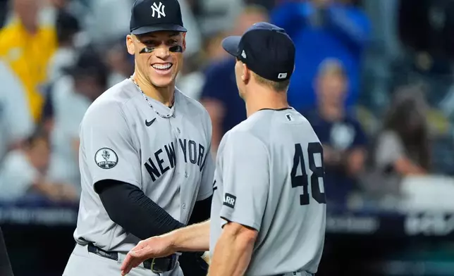 New York Yankees' Aaron Judge and Paul Goldschmidt (48) celebrate after their baseball game against the Kansas City Royals, Tuesday, May 26, 2026, in Kansas City, Mo. (AP Photo/Charlie Riedel)