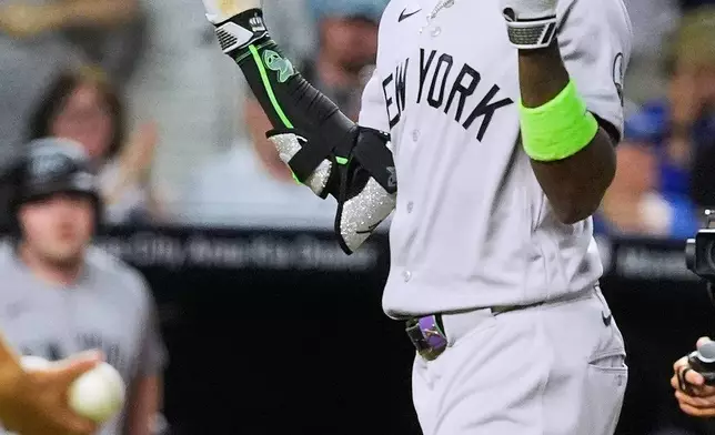 New York Yankees' Jazz Chisholm Jr. celebrates as he crosses the plate after hitting a solo home run during the eighth inning of baseball game against the Kansas City Royals, Tuesday, May 26, 2026, in Kansas City, Mo. (AP Photo/Charlie Riedel)