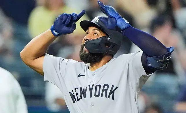 New York Yankees' Amed Rosario celebrates after hitting a two-run home run during the ninth inning of baseball game against the Kansas City Royals, Tuesday, May 26, 2026, in Kansas City, Mo. (AP Photo/Charlie Riedel)