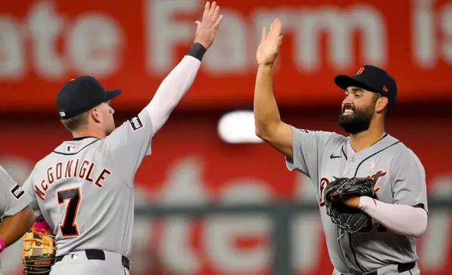 Detroit Tigers' Kevin McGonigle (7) and teammate Riley Greene, right, celebrate after their win against the Kansas City Royals during the ninth inning of a baseball game in Kansas City, Mo., Sunday, May 10, 2026. (AP Photo/Reed Hoffmann)