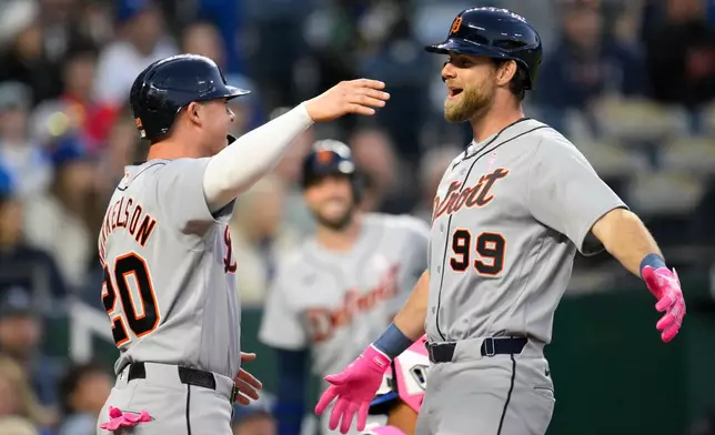 Detroit Tigers' Gage Workman (99) is congratulated by teammate Spencer Torkelson (20) after hitting a home run against the Kansas City Royals during the sixth inning of a baseball game in Kansas City, Mo., Sunday, May 10, 2026. (AP Photo/Reed Hoffmann)