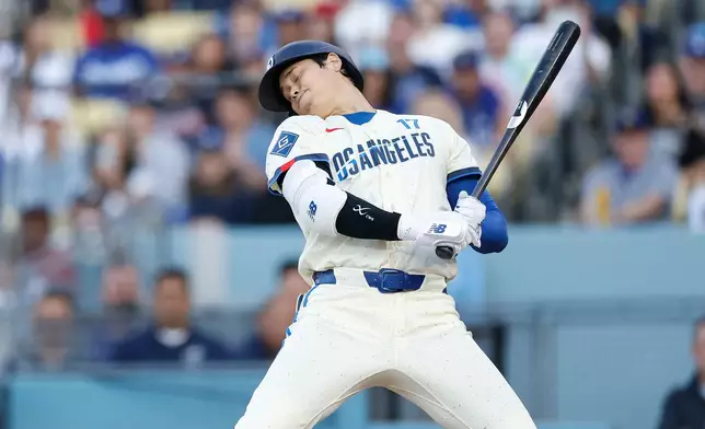 Los Angeles Dodgers designated hitter Shohei Ohtani leans back to avoid getting hit with the ball while at bat during the first inning of a baseball game against the Atlanta Braves, Saturday, May 9, 2026, in Los Angeles. (AP Photo/Caroline Brehman)