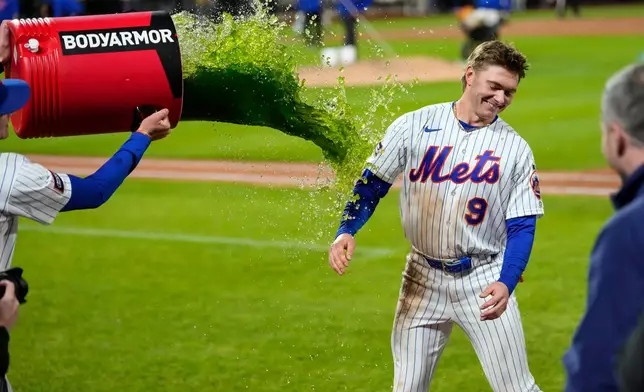 New York Mets center fielder A.J. Ewing (9) is dunked with gatorade after winning a baseball game against the Detroit Tigers, Tuesday, May 12, 2026, in New York. (AP Photo/Yuki Iwamura)
