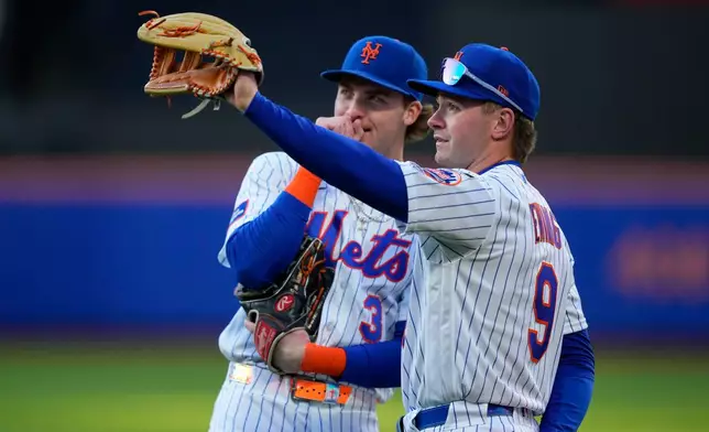 New York Mets center fielder A.J. Ewing (9), right, and New York Mets outfielder Carson Benge (3), left, talk before a baseball game against Detroit Tigers, Tuesday, May 12, 2026, in New York. (AP Photo/Yuki Iwamura)