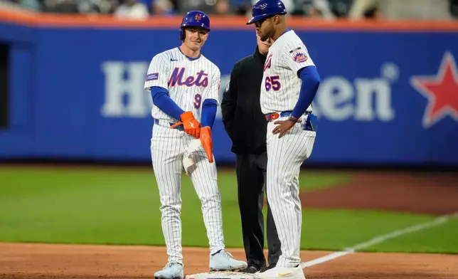 New York Mets center fielder A.J. Ewing (9), left, stands on first base drawing a walk during the second inning of a baseball game against the Detroit Tigers, Tuesday, May 12, 2026, in New York. (AP Photo/Yuki Iwamura)