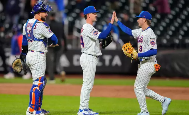New York Mets center fielder A.J. Ewing, right, celebrates with Mets' pitcher Austin Warren, center, and catcher Luis Torrens, left, after winning a baseball game against the Detroit Tigers, Tuesday, May 12, 2026, in New York. (AP Photo/Yuki Iwamura)