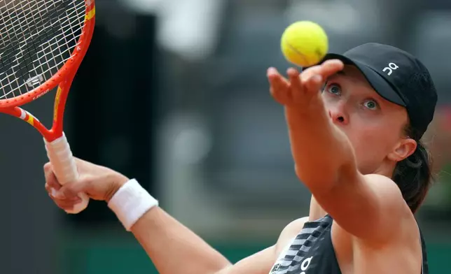 Poland's Iga Swiatek serves the ball to United State's Caty McNally during their match at the Italian Open tennis tournament, in Rome, Friday, May 8, 2026. (AP Photo/Andrew Medichini)