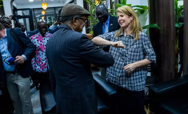 Director General of the World Health Organisation (WHO), Tedros Adhanom Ghebreyesus, left, is welcomed by UK Foreign Secretary Yvette Cooper at N'djili International Airport in Kinshasa, Congo, Thursday, May 28, 2026. (AP Photo/Samy Ntumba Shambuyi)