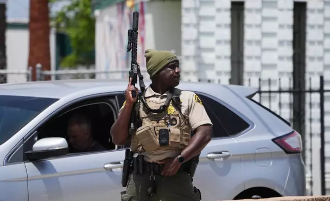 A sheriff's deputy stages at the scene of a shooting outside the Islamic Center of San Diego Monday, May 18, 2026, in San Diego. (AP Photo/Gregory Bull)