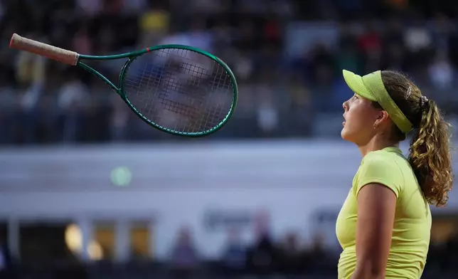 Mirra Andreeva of Russia tosses her racket after losing a point against Coco Gauff of the United States during their match at the Italian Open tennis tournament in Rome, Tuesday, May 12, 2026. (AP Photo/Alessandra Tarantino)