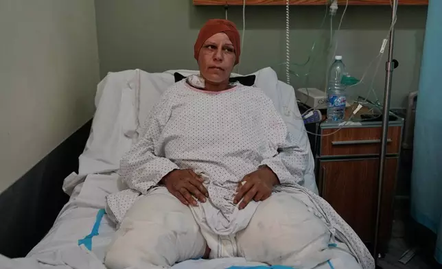 Sanaa Khalil, 35, a Syrian farmer who lost her two legs in the past days by an Israeli strike while she was working at a banana plantation, lies on a bed at a hospital in the southern port city of Tyre, Lebanon, Friday, May 1, 2026. (AP Photo/Hussein Malla)