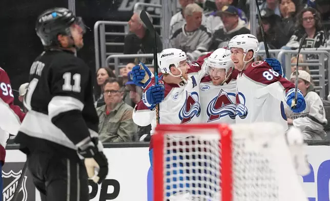 Colorado Avalanche's Devon Toews (7) celebrates after his goal with Nathan MacKinnon, third from right, and Martin Necas (88) as Los Angeles Kings' Anze Kopitar (11) reacts during the third period of Game 4 in the first round of an NHL hockey Stanley Cup playoff series Sunday, April 26, 2026, in Los Angeles. (AP Photo/Scott Strazzante)
