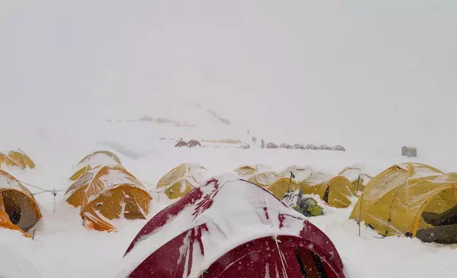 Snow covers tents during a period of inclement weather at the Everest Base Camp, Nepal, Thursday, May 7, 2026. (AP Photo/Pasang Rinzee Sherpa)