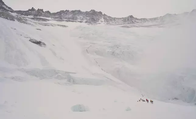Mountaineers ascend from Lhotse Face to Camp 1 on their way to the summit of Mount Everest in Nepal, Friday, May 8, 2026. (AP Photo/Pasang Rinzee Sherpa)