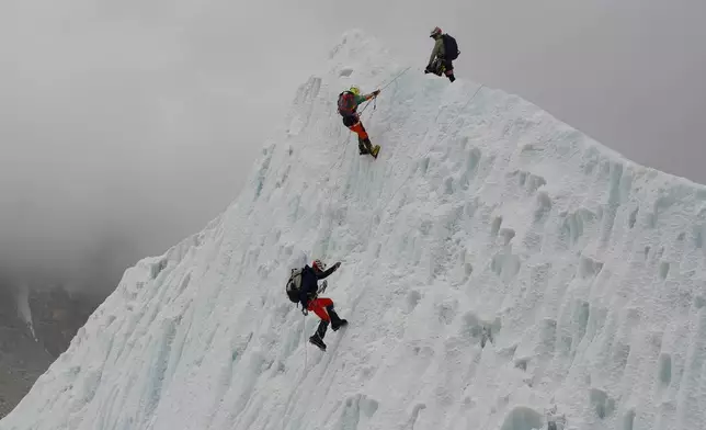 Mountaineers participate in a training session at the Khumbu Icefall as they prepare for their ascent to the summit of Mount Everest, Nepal, Saturday, May 2, 2026. (AP Photo/Pasang Rinzee Sherpa)