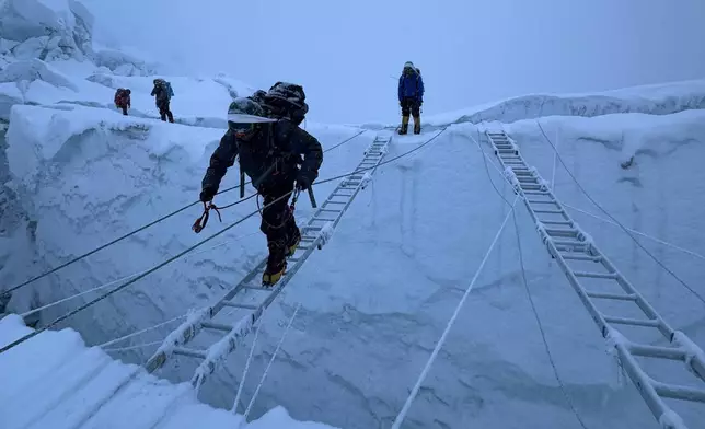 Mountaineers ascend Khumbu Icefall on their way to the summit of Mount Everest, Nepal, Thursday, May 7, 2026. (AP Photo/Pasang Rinzee Sherpa)