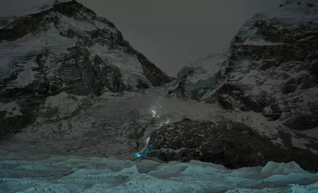 A trail of mountaineers' headlamps is visible from Everest Base Camp as climbers ascend toward the summit of Mount Everest, Nepal, Thursday, April 30, 2026. (AP Photo/Pasang Rinzee Sherpa)