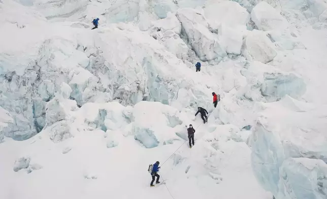 Mountaineers ascend Khumbu Icefall on their way to the summit of Mount Everest in Kathmandu, Nepal, Saturday, May 9, 2026. (AP Photo/Pasang Rinzee Sherpa)