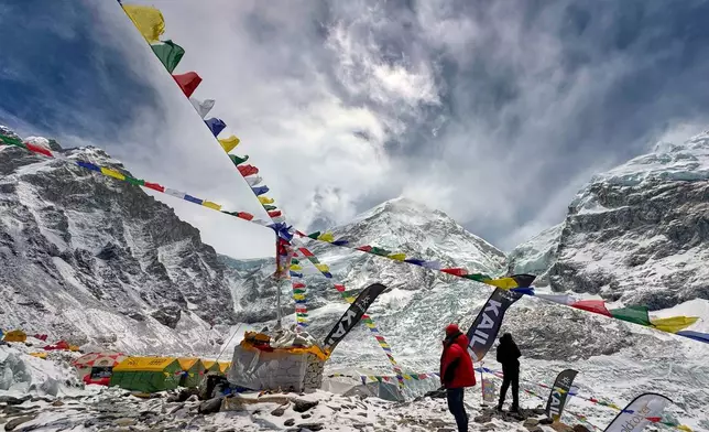 Prayers flags furl over the guides' and mountaineers' tents at the base camp of the Mount Everest, Nepal, Sunday, May 10, 2026. (AP Photo/Pasang Rinzee Sherpa)