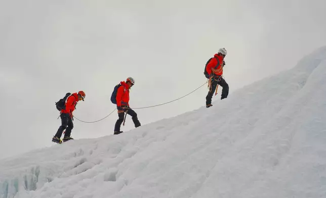 Mountaineers participate in a training session at the Khumbu Icefall as they prepare for their ascent to the summit of Mount Everest, Nepal, Sunday, May 3, 2026. (AP Photo/Pasang Rinzee Sherpa)