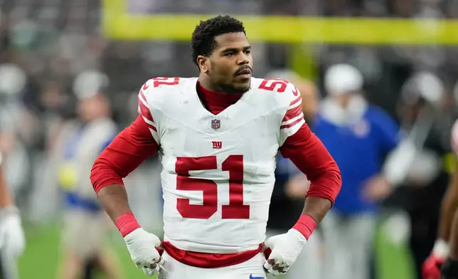 FILE - New York Giants linebacker Abdul Carter (51) walks on the field before the team's NFL football game against the Las Vegas Raiders on Dec. 28, 2025, in Las Vegas. (AP Photo/John Locher, File)
