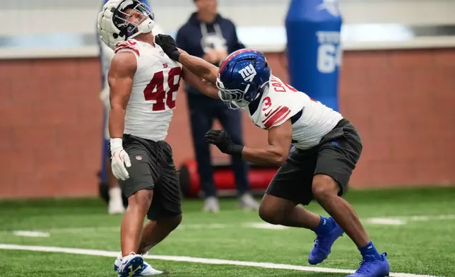 New York Giants' Abdul Carter, right, and Trace Ford participate in a drill during NFL football practice in East Rutherford, N.J., Thursday, May 21, 2026. (AP Photo/Seth Wenig)
