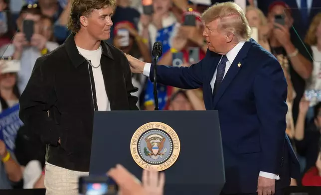 NFL quarterback Jaxson Dart, with the New York Giants, left, introduces President Donald Trump during a Fighting For American Workers event, Friday, May 22, 2026, in Suffern, N.Y. (AP Photo/Ryan Murphy)