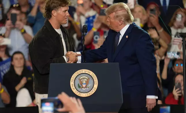 NFL quarterback Jaxson Dart, with the New York Giants, left, introduces President Donald Trump during a Fighting For American Workers event, Friday, May 22, 2026, in Suffern, N.Y. (AP Photo/Ryan Murphy)