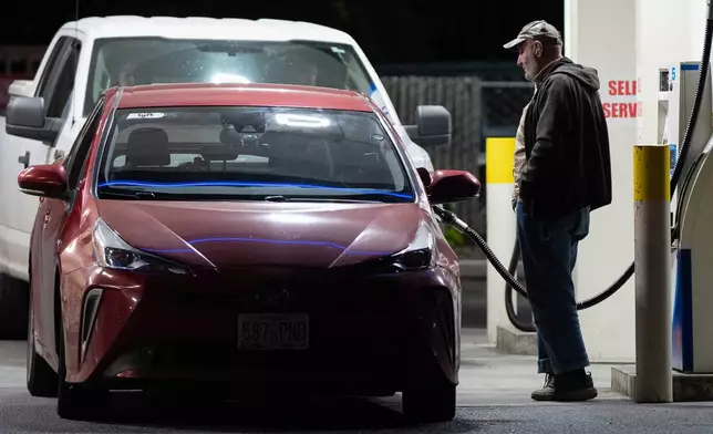 A person fills a tank with fuel at a gas station on Wednesday, May 6, 2026, in Portland, Ore. (AP Photo/Jenny Kane)