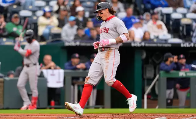 Boston Red Sox's Jarren Duran runs home to score on a single by Willson Contreras during the first inning of a baseball game against the Kansas City Royals, Tuesday, May 19, 2026, in Kansas City, Mo. (AP Photo/Charlie Riedel)