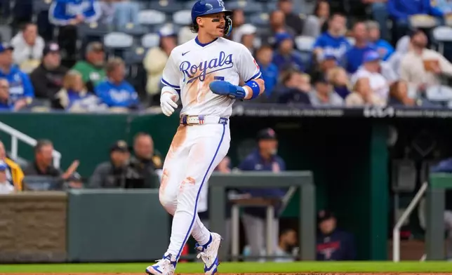 Kansas City Royals' Bobby Witt Jr. runs home to score on a double by Lane Thomas during the first inning of a baseball game against the Boston Red Sox, Tuesday, May 19, 2026, in Kansas City, Mo. (AP Photo/Charlie Riedel)